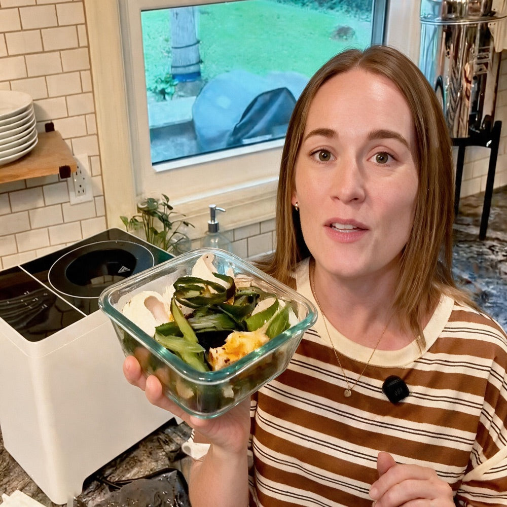 Meg in her kitchen with a container of scraps beside her composter